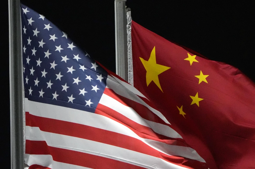 The American and Chinese flags wave, Feb. 2, 2022, in Zhangjiakou, China. (AP Photo/Kiichiro Sato, File)