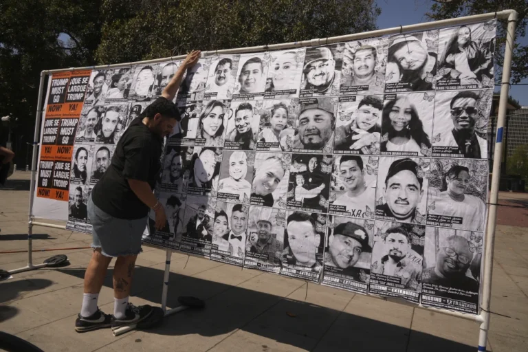 (A volunteer sets up an art installation displaying names and faces of people who have been detained, deported, or sent to offshore camps during ICE raids in Southern California, at Olvera Street Plaza in Los Angeles, on Thursday, July 3, 2025. (AP Photo/Damian Dovarganes)