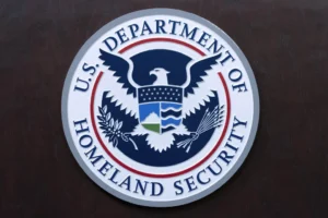 (The seal of U.S. Department of Homeland Security is seen before the news conference with Acting director of U.S. Immigration and Customs Enforcement (ICE) Todd Lyons at ICE Headquarters, in Washington, on May 21, 2025. (AP Photo/Jose Luis Magana, File)