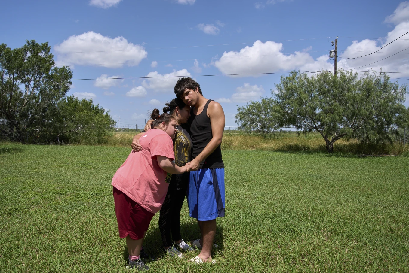 Juanita is hugged by her children, Jose, 15, and daughter Marely, 17, who has Down syndrome, June 17, 2025, during a portrait in Hidalgo County, Texas. (AP Photo: Jacquelyn Martin)