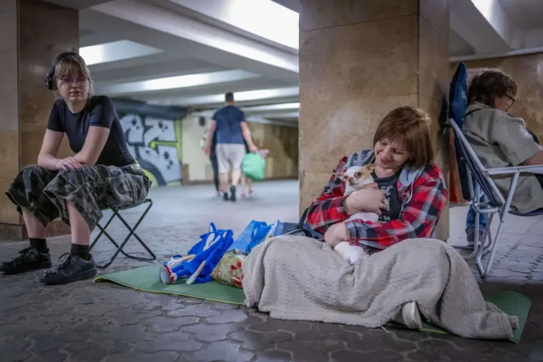 People hide in a metro station, being used as a bomb shelter, during a Russian drones attack in Kyiv, Ukraine, early hours Saturday, July 5, 2025. (AP Photo/Dan Bashakov)