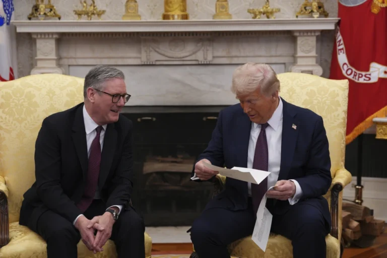 (British Prime Minister Keir Starmer, left, hands an invitation from King Charles III for a second state visit to President Donald Trump at the White House, Thursday, Feb. 27, 2025, in Washington. (Carl Court/Pool via AP, File)