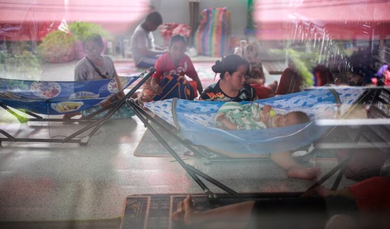 (People rest inside a temporary shelter in Srisaket province, after Thailand and Cambodia exchanged heavy artillery fire for a second day on Friday. Photo: REUTERS-Athit Perawongmetha)