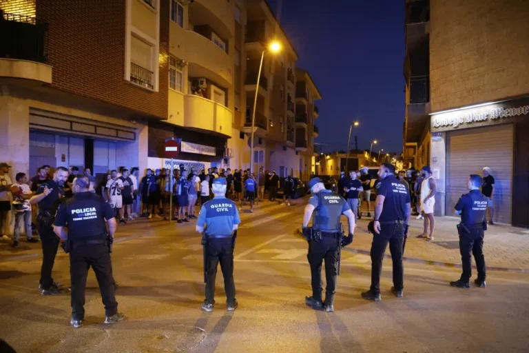 Local police officers and Spanish civil guard agents take positions during the disturbances in Torre Pacheco, eastern Spain, Friday, July 12, 2025. (Martín C./Europa Press via AP)