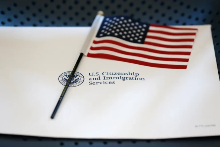 An information packet and an American flag are placed on a chair at the U.S. Citizenship and Immigration Services Miami Field Office on Aug. 17, 2018, in Miami. (AP Photo/Wilfredo Lee, File)