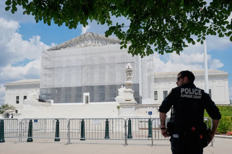 (A U.S. Supreme Court police officer stands watch as anti-abortion protesters rally outside of the Supreme Court, Thursday, June 26, 2025, in Washington. (AP Photo/Mariam Zuhaib)