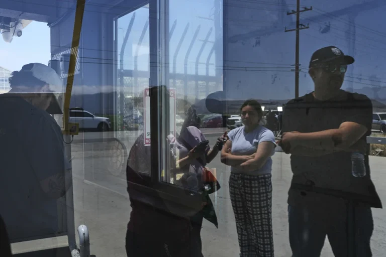 People wait outside of Glass House Farms, a day after an immigration raid on the facility, Friday, July 11, 2025, in Camarillo, Calif. (AP Photo/Jae C. Hong, File)