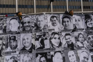 An art installation, which displays black and white images of people detained or deported as a result of ICE raids in Southern California, stands outside the federal building in Los Angeles, Thursday, July 17, 2025. (AP Photo/Jae C. Hong)