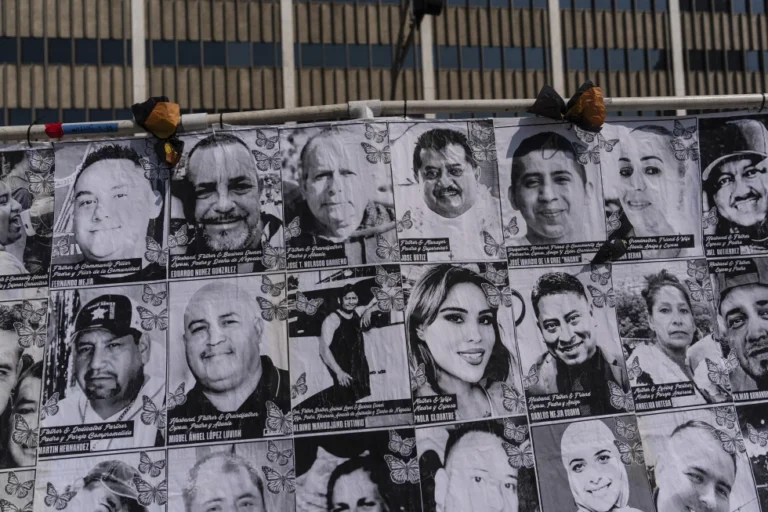 An art installation, which displays black and white images of people detained or deported as a result of ICE raids in Southern California, stands outside the federal building in Los Angeles, Thursday, July 17, 2025. (AP Photo/Jae C. Hong)