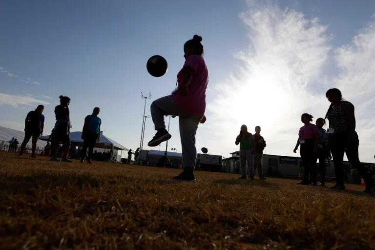 Immigrants play soccer at a new U.S. government holding center for migrant children in Carrizo Springs, Texas, July 9, 2019. (AP Photo/Eric Gay, File)
