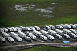 (Trailers sit parked in lines as work progresses on a migrant detention center at Dade-Collier Training and Transition facility in the Florida Everglades, July 4, 2025, in Ochopee, Fla. AP Photo: Rebecca Blackwell, file)