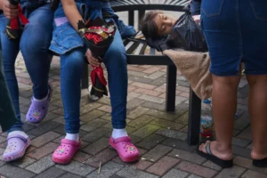 (People wait for loved ones from Guatemala deported from the United States outside La Aurora International Airport, in Guatemala City, Sunday, Aug. 31, 2025. (AP Photo: Moises Castillo)