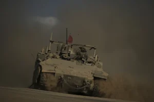 (An Israeli armored vehicle moves along the Israeli-Gaza border as seen from southern Israel, Tuesday, Sept. 16, 2025.  AP Photo: Leo Correa)
