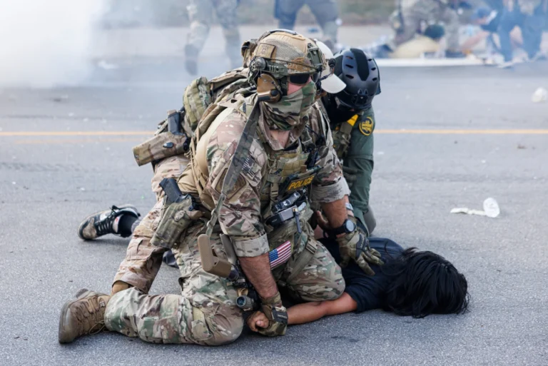 (Federal officers hold down a protestor in Brighten Park Chicago on Saturday, October 4, 2025. Photo Curtsy:  Anthony Vazquez, Sun Times)