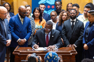 Mayor Brandon Johnson signs the ICE Free Zone Executive Order, which creates clear mechanisms to prohibit federal immigration agents from using any City-owned property in their ongoing operations in Chicago, at the Westside Justice Center in East Garfield Park; October 2025. (Vashon Jordan Jr./Office of the Mayor)