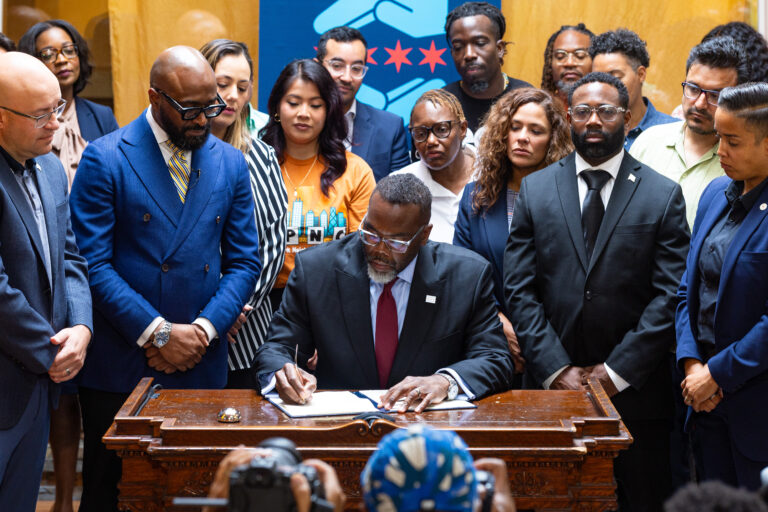 Mayor Brandon Johnson signs the ICE Free Zone Executive Order, which creates clear mechanisms to prohibit federal immigration agents from using any City-owned property in their ongoing operations in Chicago, at the Westside Justice Center in East Garfield Park; October 2025. (Vashon Jordan Jr./Office of the Mayor)