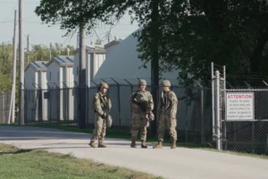 (Military personnel in uniform, with the Texas National Guard patch on, are seen at the U.S. Army Reserve Center, Wednesday, Oct. 8, 2025, in Elwood, Ill., a suburb of Chicago. (AP Photo/Laura Bargfeld)