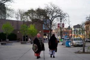 (Women walk down a street in the predominantly Somali neighborhood of Cedar-Riverside in Minneapolis on May 12, 2022.  AP Photo: Jessie Wardarski, File)