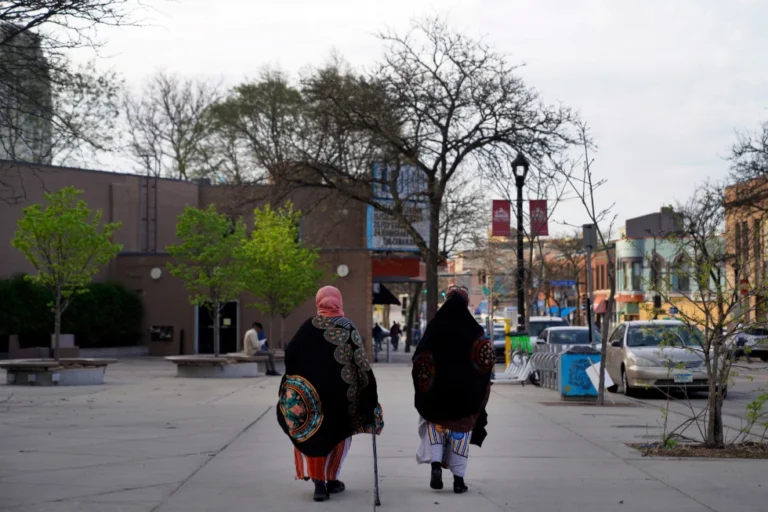 (Women walk down a street in the predominantly Somali neighborhood of Cedar-Riverside in Minneapolis on May 12, 2022.  AP Photo: Jessie Wardarski, File)