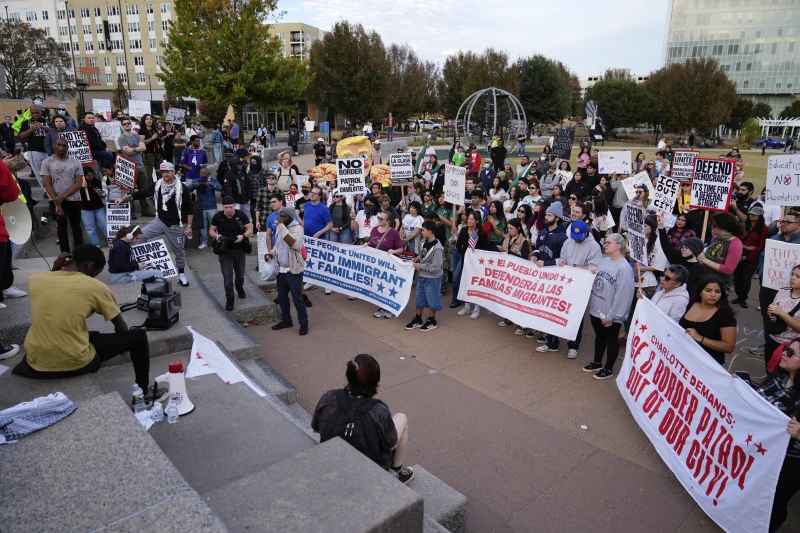 (People protest against federal immigration enforcement Saturday, Nov. 15, 2025, in Charlotte, N.C. AP Photo: Erik Verduzco)