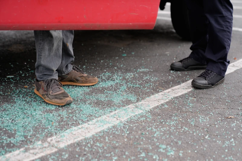 (Willy Aceituno, left, makes a police report with Charlotte-Mecklenburg Police Department officer N. Sherill, after U.S. Customs and Border Protection officers broke his window during an enforcement operation, Saturday, Nov. 15, 2025, in Charlotte, N.C.  AP Photo: Erik Verduzco)