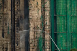 (Firefighters work to extinguish a fire which broke out Wednesday at Wang Fuk Court, a residential estate in the Tai Po district of Hong Kong’s New Territories, Thursday, Nov. 27, 2025.  AP Photo: Chan Long Hei)