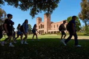 (Students walk past Royce Hall on the UCLA campus in Los Angeles, Aug. 15, 2024. (AP Photo/Damian Dovarganes, File)