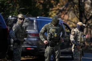 (U.S. Border Patrol agents look on, Monday, Nov. 17, 2025, in Charlotte, N.C. AP Photo: Matt Kelley)
