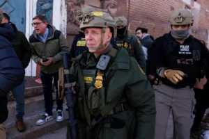(Border Patrol Cmdr. Gregory Bovino walks alongside his agents after they detain an individual near West 27th Street and South Ridgeway Avenue in the Little Village neighborhood of Chicago, Tuesday, Dec. 16, 2025.  Photo: Anthony Vazquez-Chicago Sun-Times via AP)