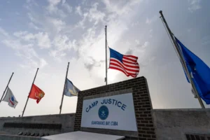 (In this photo reviewed by U.S. military officials, flags fly at half-staff at Camp Justice, Aug. 29, 2021, in Guantanamo Bay Naval Base, Cuba. (AP Photo/Alex Brandon, File)