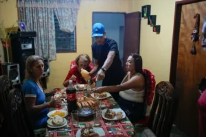 (Mariela Gómez, right, and her partner Abraham Castro, a Venezuelan migrant couple, sit for Christmas dinner at Castro’s parents’ home in Maracay, Venezuela, early Thursday, Dec. 25, 2025. The couple abandoned their journey to the United States and returned home from Mexico by land and sea following President Donald Trump’s immigration crackdown.  AP Photo: Matias Delacroix)