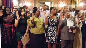 (New citizens take the oath during a special naturalization ceremony at Baltimore’s Washington Monument on July 4, 2015. DHS photo by Barry Bahler)