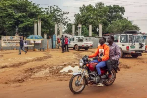 (Motorists pass outside Bor State Hospital in Bor, South Sudan, Monday, Aug. 18, 2025. (AP Photo/Caitlin Kelly, File)