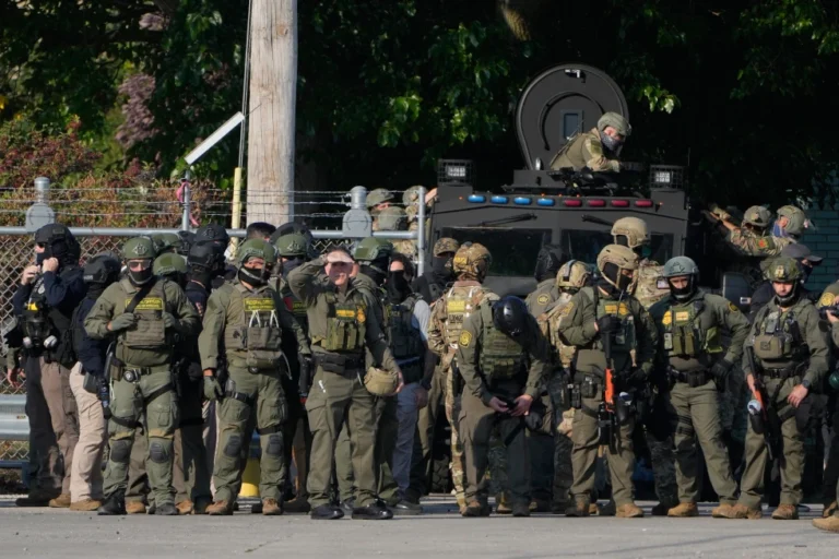 (Greg Bovino, the chief patrol agent for the U.S. Border Patrol El Centro sector, center, stands with federal immigration agents near an Immigration and Customs Enforcement facility in Broadview, Ill., Oct. 3, 2025.  AP Photo: Erin Hooley, File)