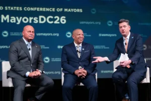 (Oklahoma City Mayor David Holt, right, speaks during a panel discussion with Fresno, Calif. Mayor Jerry Dyer, left, and Omaha, Neb. Mayor John Ewing, Jr. during the 94th Winter Meeting of the U.S. Conference of Mayors, Wednesday, Jan. 28, 2026 in Washington. (AP Photo/Kevin Wolf)