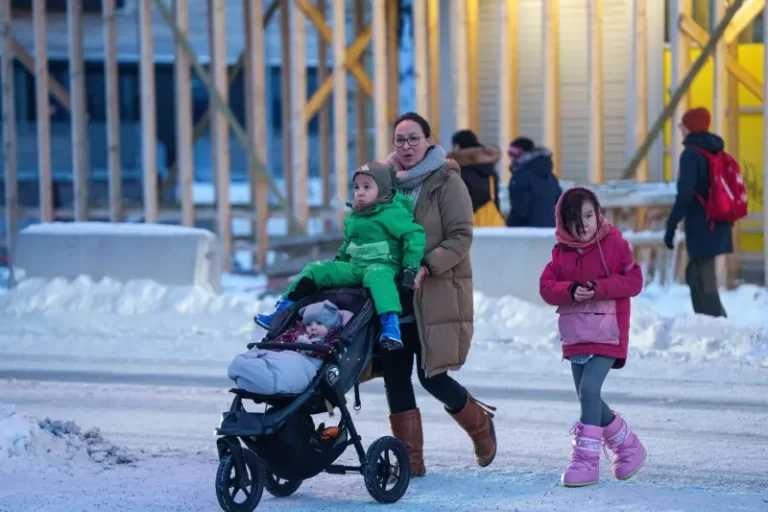 (A woman pushes a stroller with her children in Nuuk, Greenland, Thursday, Jan. 15, 2026. AP Photo: Evgeniy Maloletka, File)