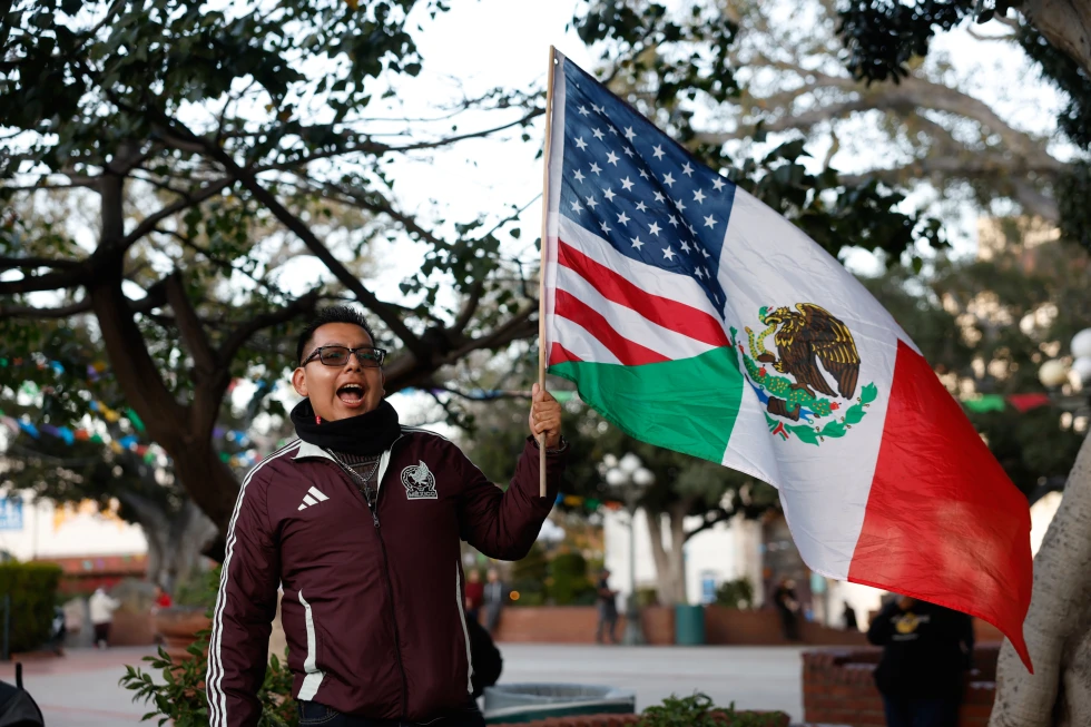 (A demonstrator waves a combination American and Mexican flag during a protest in response to the Minneapolis fatal shooting of 37-year-old Alex Pretti Saturday, Jan. 24, 2026, in Los Angeles.  AP Photo: Caroline Brehman)