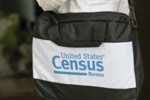 (A briefcase of a census taker is seen as she knocks on the door of a residence, Aug. 11, 2020, in Winter Park, Fla.  AP Photo: John Raoux, File)