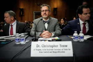 (Christopher Yeaw, center, arrives to a Senate Foreign Relations Committee confirmation hearing on his nomination to be an assistant Secretary of State, Nov. 19, 2025, on Capitol Hill in Washington. AP Photo: Julia Demaree Nikhinson, File)