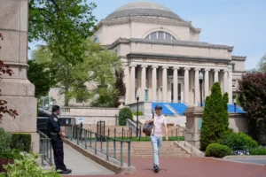 (A New York City police officer keeps watch on the campus of Columbia University in New York, May 6, 2024.  AP Photo: Seth Wenig, File)