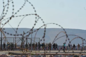 (Migrants rescued south of Crete walk after their arrival at the the port of Lavrio, Greece, on Thursday, July 10, 2025. AP Photo: Petros Giannakouris)