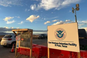 (A sign marks the entrance to a series of hardened tents at the Camp East Montana immigrant detention center in the desert at a U.S. Army base on the outskirts of El Paso, Texas, Friday, Feb. 13, 2026.  AP Photo: Morgan Lee)
