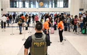 (An ICE officer at George Bush Intercontinental Airport in Houston, Texas. Photo: Ronaldo Schmid-AFP)