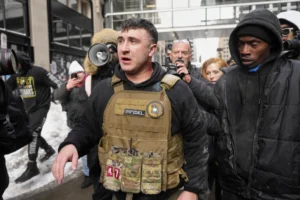 (Jake Lang, center, walks away from counter protesters after an altercation near Minneapolis City Hall, Saturday, Jan. 17, 2026, in Minneapolis. AP Photo: Yuki Iwamura,File)
