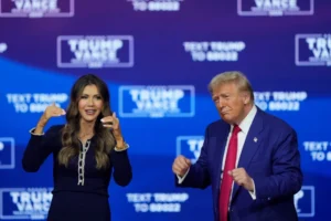 Republican presidential nominee former President Donald Trump and South Dakota Gov. Kristi Noem dance to the song “Y.M.C.A.” at a campaign town hall at the Greater Philadelphia Expo Center & Fairgrounds, Oct. 14, 2024, in Oaks, Pa. (AP Photo/Matt Rourke, File)