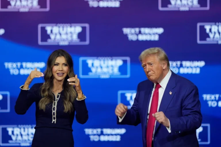 Republican presidential nominee former President Donald Trump and South Dakota Gov. Kristi Noem dance to the song “Y.M.C.A.” at a campaign town hall at the Greater Philadelphia Expo Center & Fairgrounds, Oct. 14, 2024, in Oaks, Pa. (AP Photo/Matt Rourke, File)