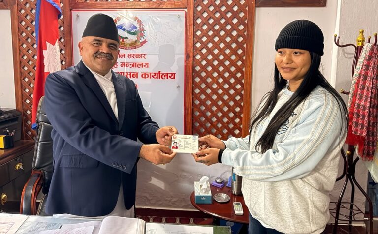  
(Chief District Officer Rabindra Acharya (left) handing over the citizenship to Seema Pun. Photo: Amrit Prasad Paudel)