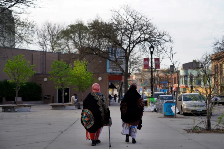 (Women walk down a street in the predominantly Somali neighborhood of Cedar-Riverside in Minneapolis on May 12, 2022.  AP Photo: Jessie Wardarski, File)