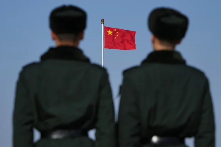 (Soldiers stand watch against the national flag on Tiananmen Square during a press conference ahead of the opening of the Chinese People’s Political Consultative Conference (CPPCC) held at the Great Hall of the People in Beijing, China, Tuesday, March 3, 2026.  AP Photo: Andy Wong)