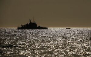 (In this photo from 2020, a Turkish coast guard vessel approaches a life raft with migrants in the Aegean Sea, between Turkey and Greece.  Photo: AP]